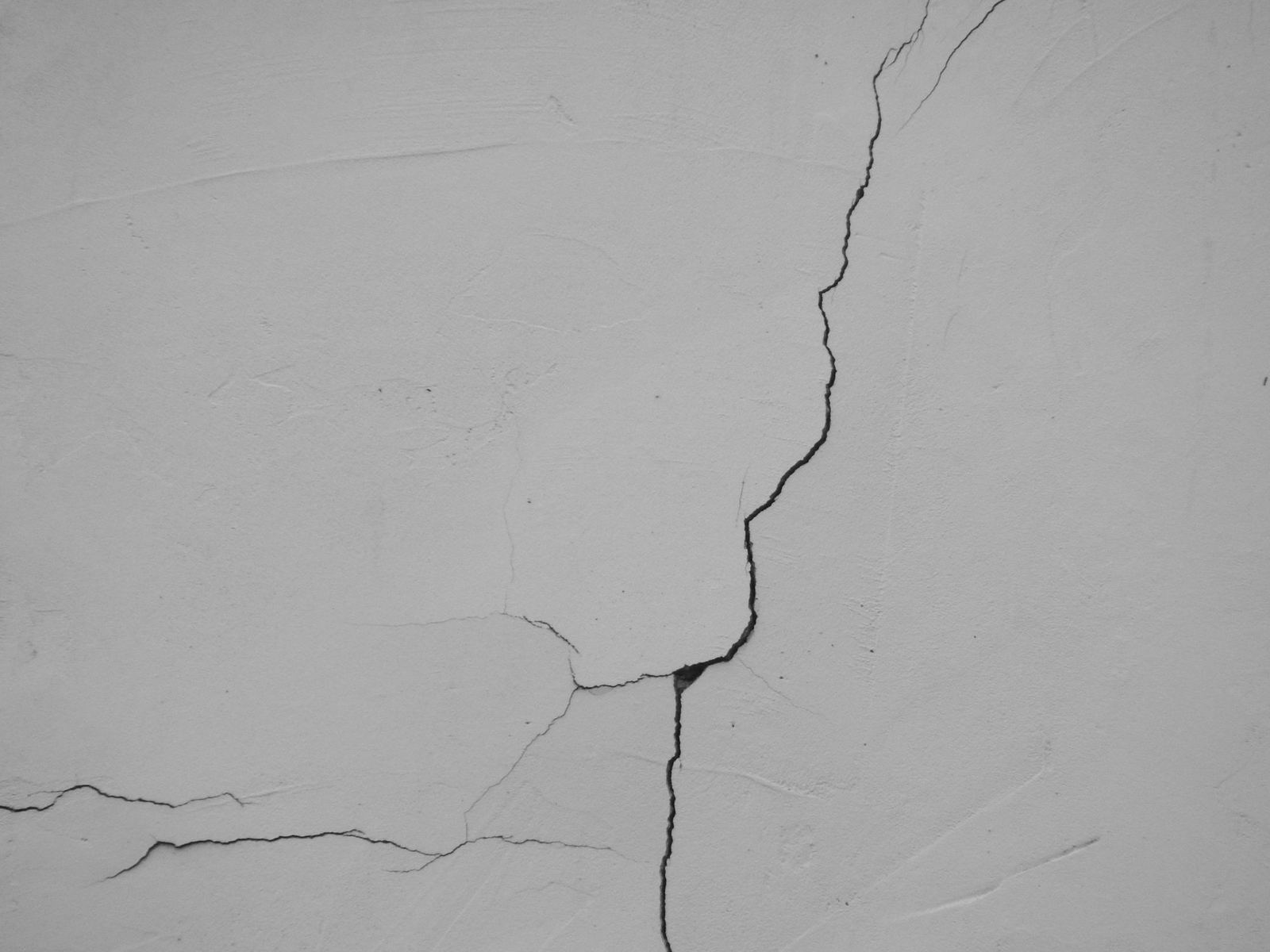 A crack branching across a painted interior wall